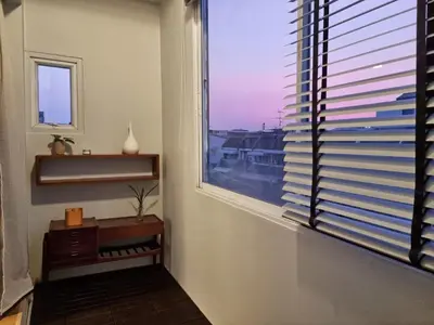 a room with a window with a view of a city at Human Touch Room - Soulful Bangkok Hideout in Lat Krabang
