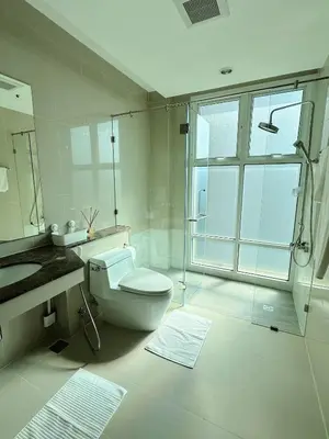 a bathroom with a toilet and a sink and a shower at The Prime 11 Sukhumvit 11 2BR near BTS Nana in Bangkok