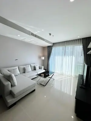 a white living room with a couch and a table at The Prime 11 Sukhumvit 11 2BR near BTS Nana in Bangkok