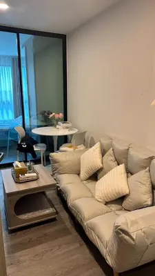 a living room with a couch and a table at 1Bed Room Near Airport DMK BTS Swimming Pool Gym Monthly rental in Sathani Lak Si