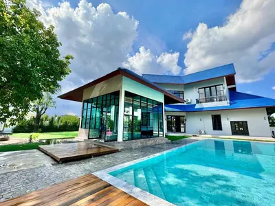 a house with a swimming pool in front of a house at Tarzan DZ Bangkok Luxurious Villa in Sathani Ban Hua Mak