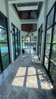 an empty lobby with large windows and a ceiling at Tarzan DZ Bangkok Luxurious Villa in Sathani Ban Hua Mak