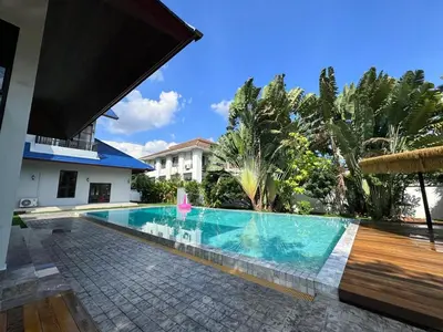 a swimming pool in front of a house at Tarzan DZ Bangkok Luxurious Villa in Sathani Ban Hua Mak