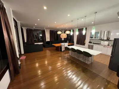 a kitchen and living room with a table and chairs at Tarzan DZ Bangkok Luxurious Villa in Sathani Ban Hua Mak