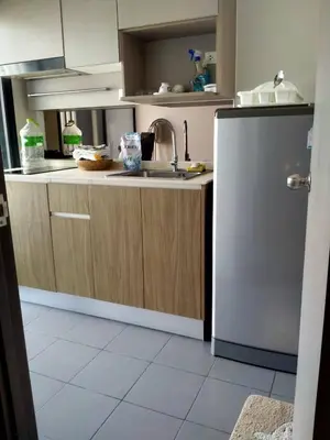 a kitchen with a sink and a refrigerator at Cybercarer Victoria St NSW 2011 Australia in Bangkok Yai