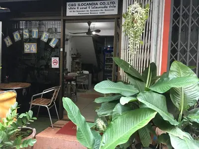 a restaurant with a plant in front of a door at Hostel 24 in Bangkok