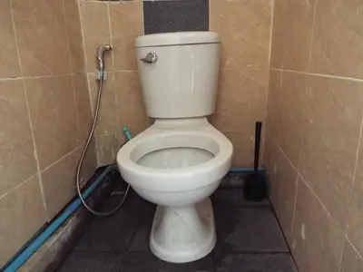 a bathroom with a white toilet in a stall at Hostel 24 in Bangkok