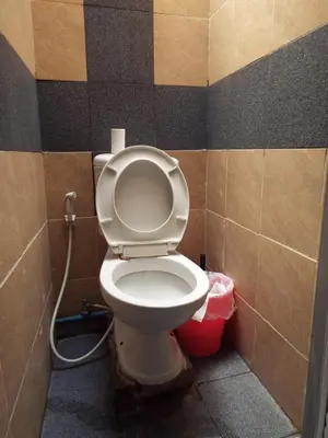 a bathroom with a toilet with the lid up at Hostel 24 in Bangkok