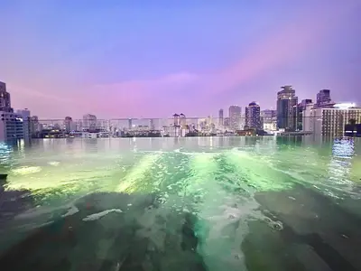 a large body of water with a city in the background at Luxury 2Bed Duplex - 1min From Thonglor BTS in Bangkok
