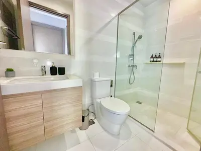 a bathroom with a toilet and a sink and a shower at Luxury 2Bed Duplex - 1min From Thonglor BTS in Bangkok