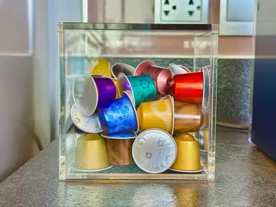 a clear glass container filled with different colored cups at Luxury 2Bed Duplex - 1min From Thonglor BTS in Bangkok