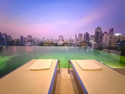 two beds on a balcony with a view of a city at Luxury 2Bed Duplex - 1min From Thonglor BTS in Bangkok