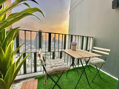 a table and chairs on a balcony with a view at Luxury 2Bed Duplex - 1min From Thonglor BTS in Bangkok