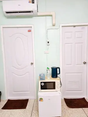 a kitchen with a white door and a microwave at 201-STP Homely room Free Wi-Fi and Near BTS in Sathani Bang Khen
