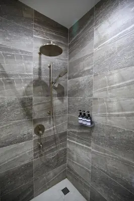 a bathroom with a shower with a shower head at Chic Ekkamai Escape Near BTS, Dining & Nightlife in Bangkok