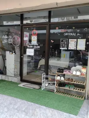 a store front with a christmas sign in the window at Hostel 24 Backpackers in Bangkok