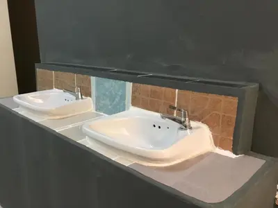 a bathroom with two sinks in a counter at Hostel 24 Backpackers in Bangkok