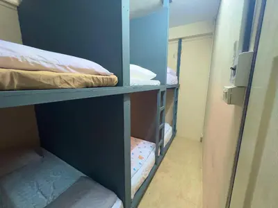a room with two bunk beds in a room at Hostel 24 Backpackers in Bangkok