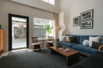 a living room with a blue couch and a table at nap in a blue moon in Bangkok