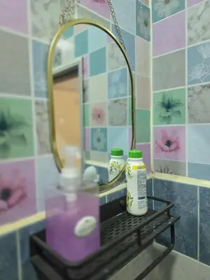 a bathroom sink with a mirror and a bottle of soap at 103 Olan Place Peaceful Apartment near SkyTrain and free Wi-Fi in Bangkok