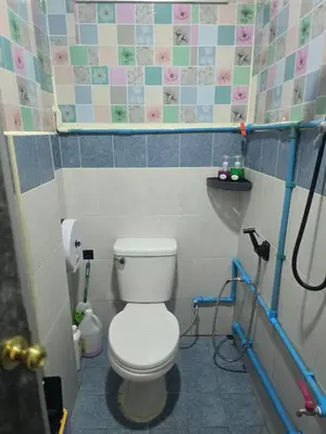 a small bathroom with a toilet and a sink at 103 Olan Place Peaceful Apartment near SkyTrain and free Wi-Fi in Bangkok