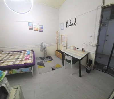 a room with a bed and a table and a desk at 103 Olan Place Peaceful Apartment near SkyTrain and free Wi-Fi in Bangkok