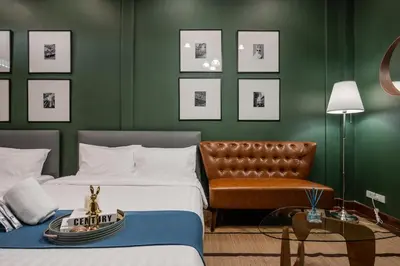a hotel room with two beds and a chair at Arun Sa Wad - Yaowarat 27 in Bangkok
