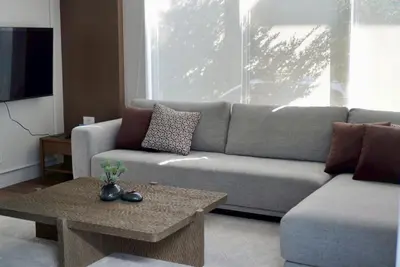 a living room with a couch and a coffee table at Around Ari Hostel in Bangkok