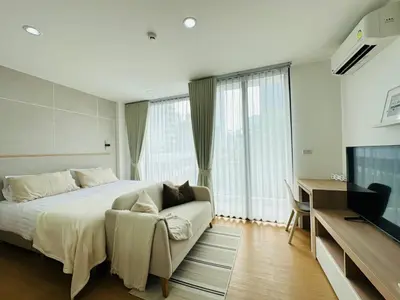 a bedroom with a bed and a couch and a television at 6th Avenue Sukhumvit BKK 407 BTS Asoke Nana in Bangkok