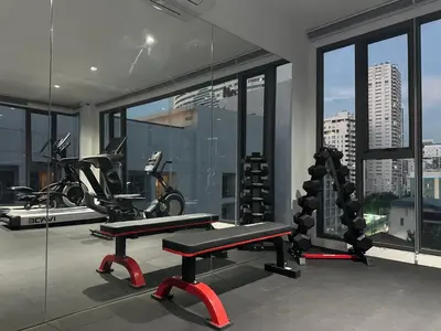 a gym with a bike and a bench in a room at 6th Avenue Sukhumvit BKK 407 BTS Asoke Nana in Bangkok