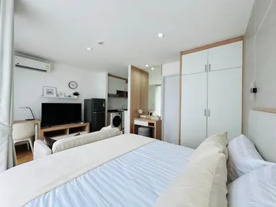 a white bedroom with a bed and a television at 6th Avenue Sukhumvit BKK 407 BTS Asoke Nana in Bangkok