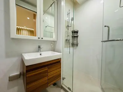 a bathroom with a sink and a glass shower at 6th Avenue Sukhumvit BKK 407 BTS Asoke Nana in Bangkok