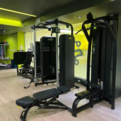 a gym with several tread machines in a room at jasminespace in Khlong San