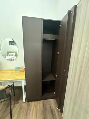 a black closet with a table and a mirror at The Gabriel House in Ban Bang Khen (1)