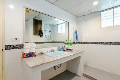 a bathroom with a sink and a mirror at Surawong Condominium in Bangkok