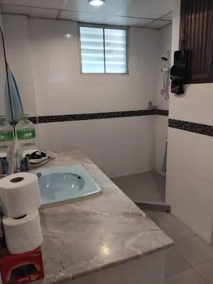 a bathroom with a sink and a tub at Surawong Condominium in Bangkok