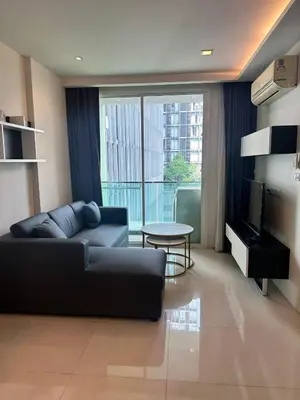 a living room with a black couch and a table at Spacious Sukhumvit Condo near EmQuartier in Bangkok