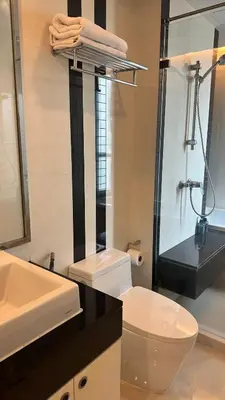 a bathroom with a toilet and a sink and a shower at Spacious Sukhumvit Condo near EmQuartier in Bangkok
