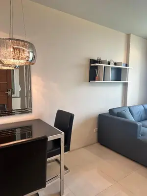 a living room with a couch and a table at Spacious Sukhumvit Condo near EmQuartier in Bangkok