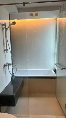 a shower in a bathroom with a bath tub at Spacious Sukhumvit Condo near EmQuartier in Bangkok