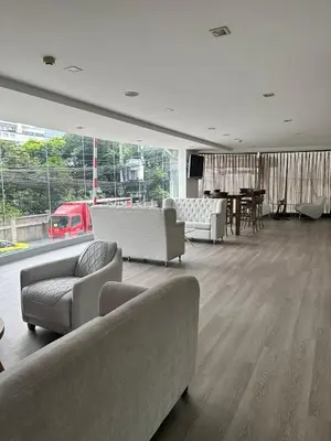 a living room with couches and a dining room with a table at Spacious Sukhumvit Condo near EmQuartier in Bangkok