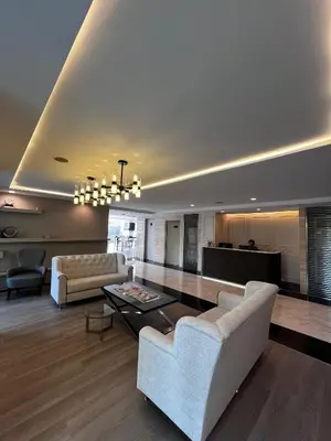 a living room with a couch and a table at Spacious Sukhumvit Condo near EmQuartier in Bangkok