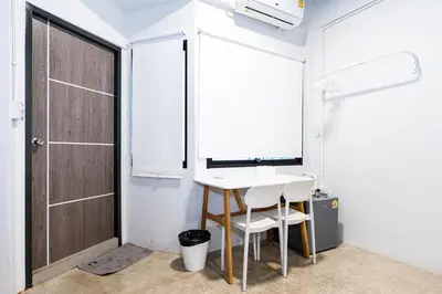 a small room with a table and a door at xx Yellow Place Sukhumvit Soi 2 -เยลโล เพลส สุขุมวิทซอย 2 in Bangkok