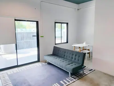 a black bench in a room with a table at xx Yellow Place Sukhumvit Soi 2 -เยลโล เพลส สุขุมวิทซอย 2 in Bangkok