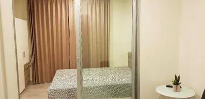 a bedroom with a bed and a mirror at Mari's space Riverview in Nonthaburi