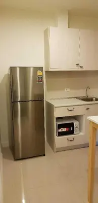 a kitchen with a stainless steel refrigerator and a sink at Mari's space Riverview in Nonthaburi
