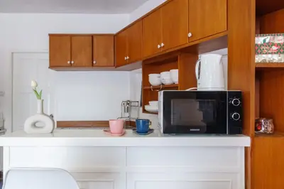 a kitchen with a microwave and a counter top at Charming 3-Storey house near BTS Onnut Station in Bangkok