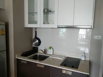 a kitchen with white cabinets and a sink at Modern Place Watthana, Thonglor BTS, Sukhumvit in Bangkok
