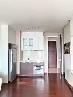 a kitchen with white cabinets and stainless steel appliances at Modern Place Watthana, Thonglor BTS, Sukhumvit in Bangkok