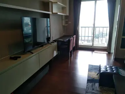 a living room with a flat screen tv and a couch at Modern Place Watthana, Thonglor BTS, Sukhumvit in Bangkok